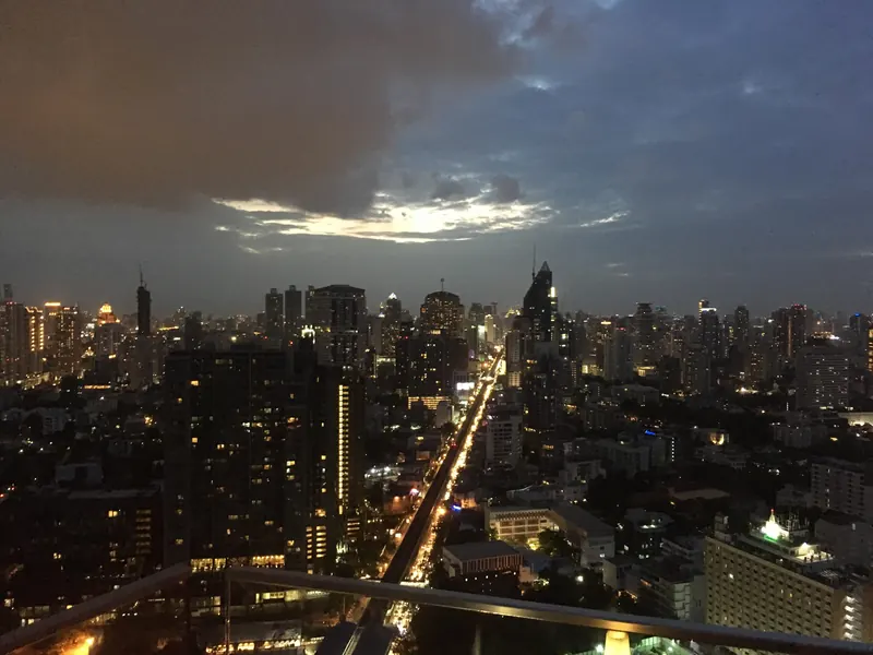 Bangkok skyline at night seen from a rooftop